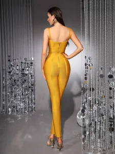 Back view of a slim fit yellow bandage jumpsuit with zipper detail and sequins.