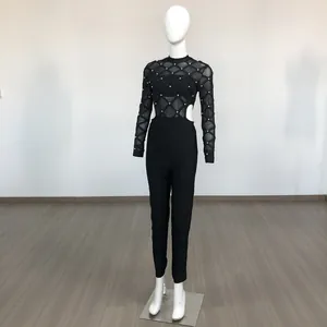 Black long sleeve mesh jumpsuit with studded diamond pattern and sexy waist cutouts on mannequin