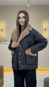 Front view of an elegant dark padded jacket with a tan faux fur collar and gold buttons.