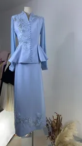 Elegant light blue long sleeve suit set with textured floral beadwork on mannequin