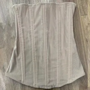 Detail view of the breathable mesh fabric and boning on this high-stretch nude corset top