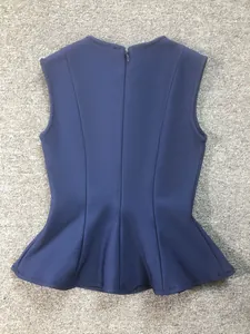 Detailed back view of a navy blue peplum bandage top featuring a zipper closure