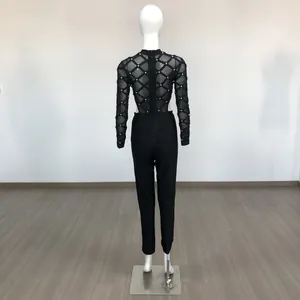 Elegant back view of a black sheer mesh jumpsuit with silver studs and bandage pants