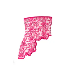 Detail of pink jacquard bandage tube top featuring an irregular scalloped hemline.