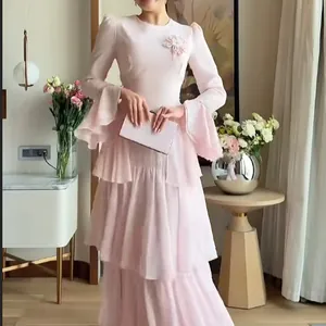 Elegant light pink long-sleeved tiered dress with a delicate flower applique detail