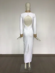 Back view of white long-sleeve bandage dress with gold beaded collar and open back