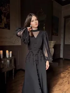 Elegante vestido largo francés negro con mangas abullonadas de malla y bordado floral fino.