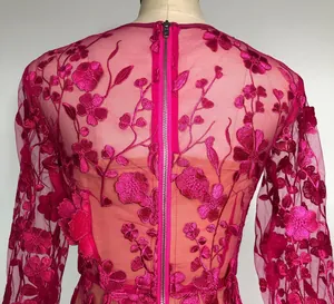 Detail view of fuchsia floral lace dress with 3D embroidery and central back zipper closure