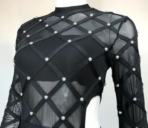 Detailed view of black mesh bodysuit with sheer bandage design and pearl beads