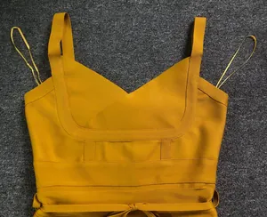 Detail view of mustard yellow V-neck bandage bodysuit with slimming waist tie straps