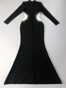 Elegant black long sleeve evening dress featuring rhinestone side cut-out details