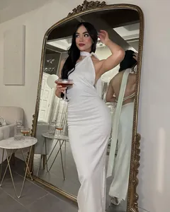 Elegant white backless halter neck dress featuring pearl bead detailing on the back.