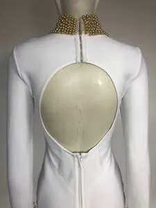 Back detail view of elegant white long sleeve bandage dress with gold beaded collar