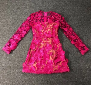 Detail view of the intricate 3D floral embroidery on this magenta long sleeve lace dress