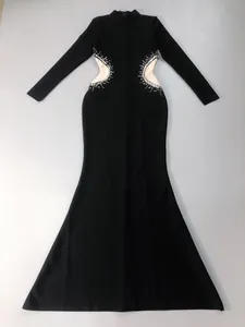 Elegant black long-sleeved evening gown with sparkling rhinestone waist cut-out details.