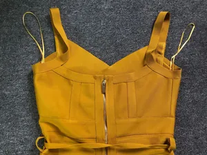 Close-up back view of mustard yellow V-neck bandage jumpsuit showing gold zipper detail