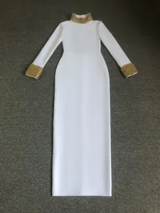 Intricate gold beadwork details on the high neck and cuffs of this elegant white bandage dress