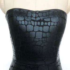 Detailed macro view of black crocodile pattern texture on a strapless tube top dress bodice.