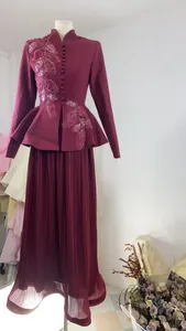 Elegant burgundy peplum blazer and pleated maxi skirt set with leaf embroidery.