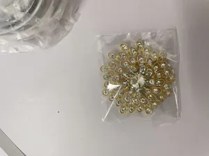 Macro view of a gold-toned sunburst brooch embellished with clear sparkling crystals