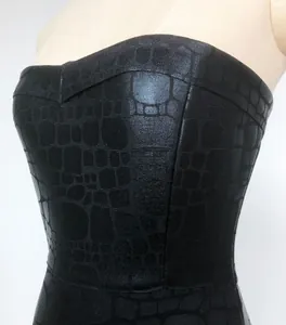 Close-up detail of a premium black strapless dress featuring crocodile skin embossed texture