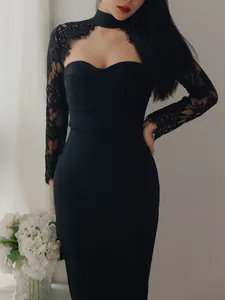 Detail shot of an elegant black bandage dress featuring lace sleeves and a halter neckline