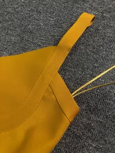 Close-up detail showing the high-quality mustard yellow bandage fabric and shoulder strap
