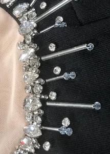 Detailed macro view of shimmering crystal rhinestones and beadwork on black evening dress