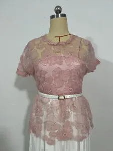 Detailed view of elegant pink lace floral dress featuring delicate pearl embellishments