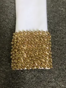Elegant white bandage dress sleeve detail with gold beaded cuff decoration