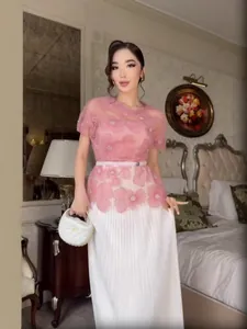 Elegant pink lace floral top with white pleated maxi skirt for 2025 spring fashion