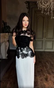 Elegant black lace floral dress with white pleated skirt for women.