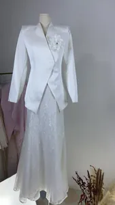 Elegant white blazer with flower brooch and long lace skirt suit for formal occasions