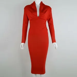 Detailed view of elegant deep V-neck and draped waist on a red long sleeve bandage dress