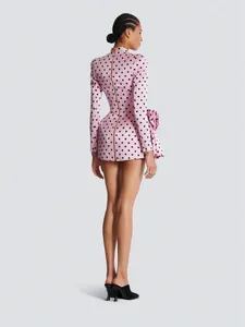 Elegant pink polka dot mini dress with long sleeves and decorative 3D floral detail