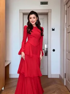 Elegant red long-sleeved tiered maxi dress with detailed flower appliqué and ruffled skirt
