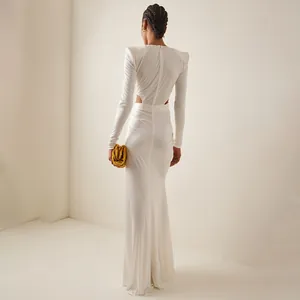 Back view of elegant white long-sleeve maxi dress with cut-out detail and mermaid skirt