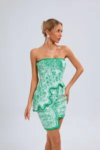 Detail shot of green jacquard strapless dress with irregular hemline and wavy trim.