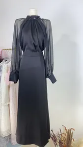 Elegant black French evening gown with sheer lantern sleeves and beaded neckline detail.