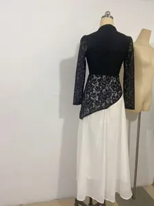Detailed back view of an elegant black and white lace evening dress with asymmetrical hem