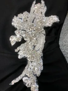 Exquisite detail of handcrafted crystal flower applique on black bandage evening gown