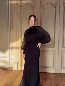Elegant black French evening gown with sheer lantern sleeves and sequined high neck collar.