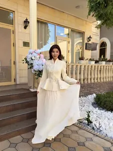 Elegant cream embroidered suit jacket with matching long pleated skirt two-piece set.