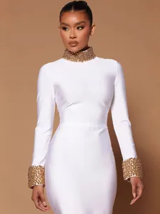 Elegant white long sleeve bodycon bandage dress featuring gold beaded high neck and cuffs