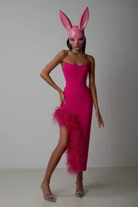 Detail view of fuchsia strapless evening dress with luxurious ostrich feather slit