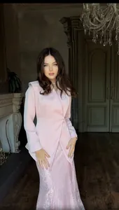 Elegant pink textured blazer and skirt set shown on a model in a luxury interior.
