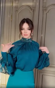 Elegant teal silk evening gown featuring a detailed view of the embellished high neckline