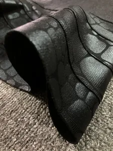 Macro close-up showing the textured black bronzing bandage fabric with crocodile pattern
