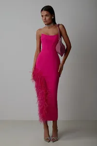 Elegant hot pink strapless bandage dress with ostrich feather slit detail on model.
