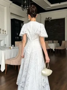 Elegant white lace maxi dress with tassel sleeves and a lace-up back design.